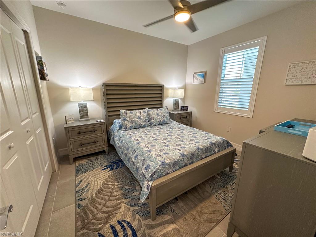 250 Indies Drive East, Unit 101 Naples, FL 34114 - Photo 17 of 49 a bedroom with a bed and a window