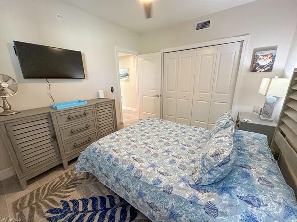a bedroom with a bed and a flat screen tv