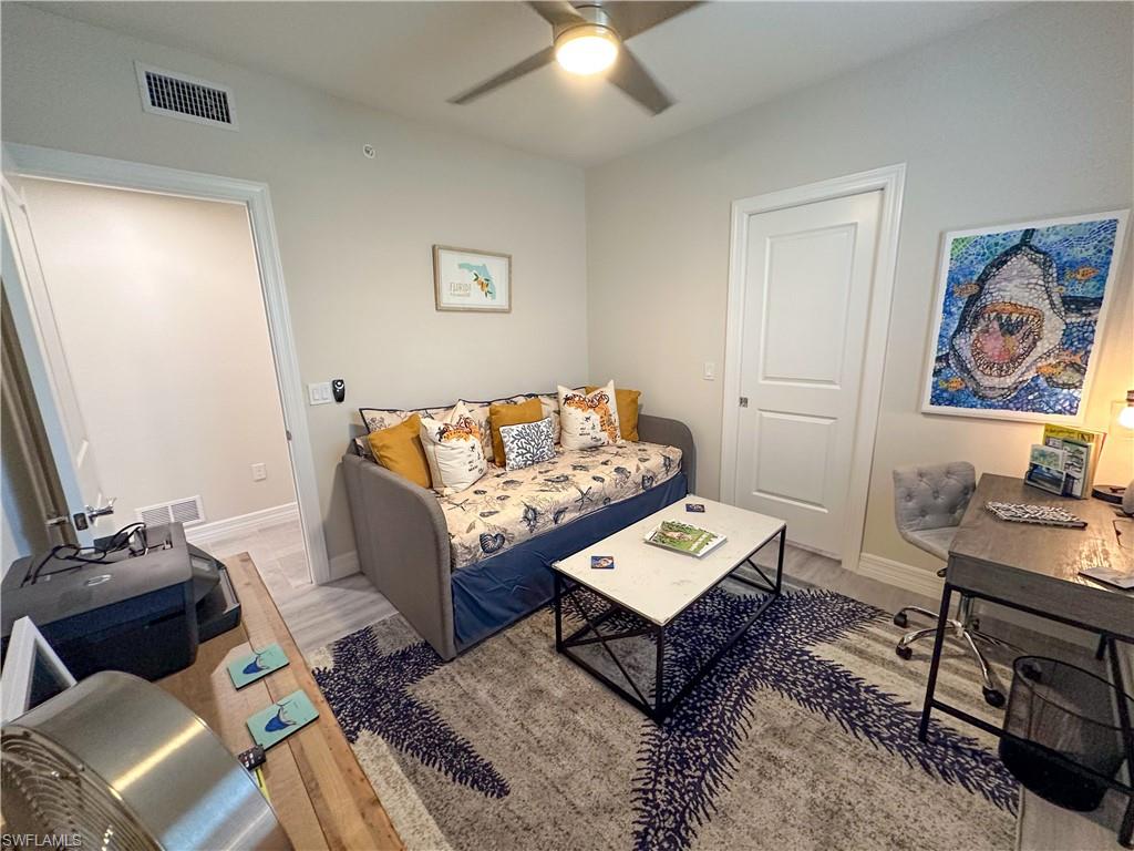 250 Indies Drive East, Unit 101 Naples, FL 34114 - Photo 23 of 49 a living room with furniture and rug