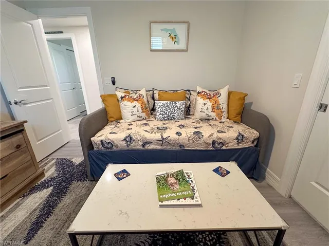 a bed sitting in a bedroom next to a window