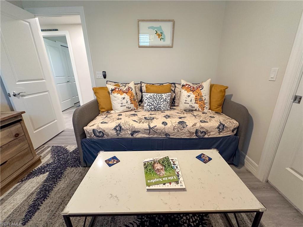 250 Indies Drive East, Unit 101 Naples, FL 34114 - Photo 24 of 49 a bed sitting in a bedroom next to a window