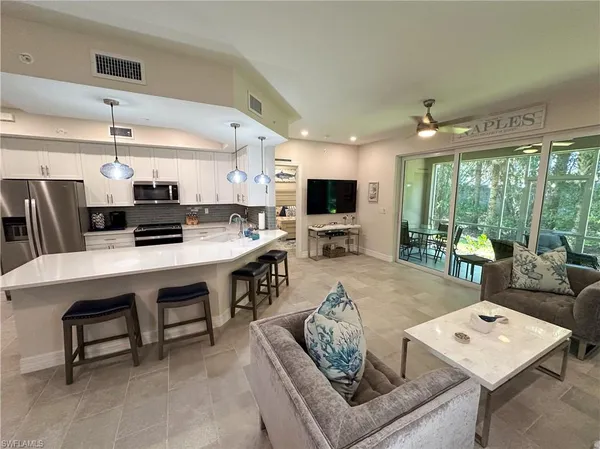 a living room with furniture and flat screen tv