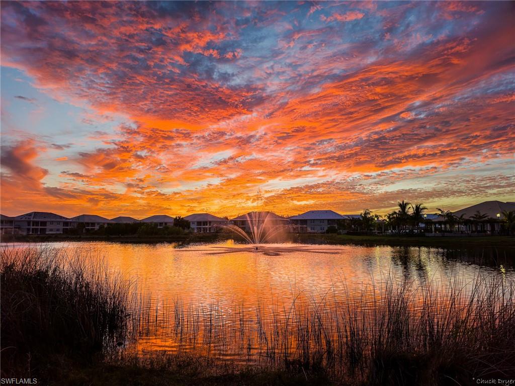 250 Indies Drive East, Unit 101 Naples, FL 34114 - Photo 49 of 49 a view of a lake with houses in the back