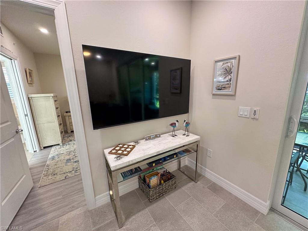 250 Indies Drive East, Unit 101 Naples, FL 34114 - Photo 9 of 49 a view of a hallway with seating area