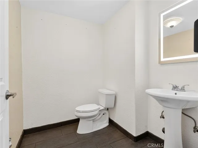 a white toilet sitting next to a bathroom sink