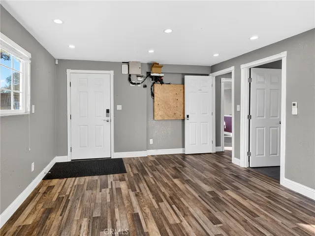 a view of wooden floor in an empty room with a window