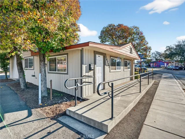 a front view of a house with sitting area