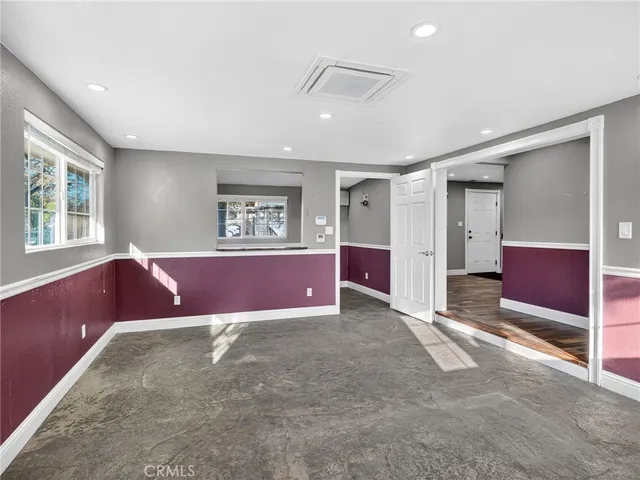 a spacious bedroom with a bed and a couch