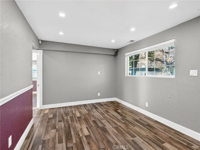 a view of room with window and wooden floor