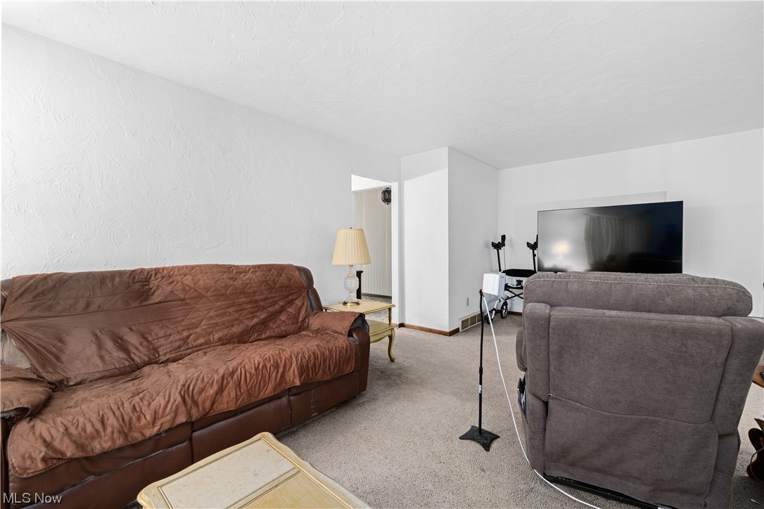32051 Avon Road Avon, OH 44011 - Photo 14 of 32 Living room with light colored carpet