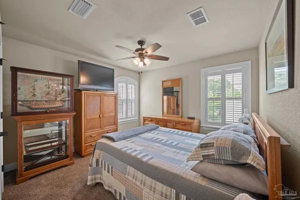 a spacious bathroom with a granite countertop tub shower and mirror