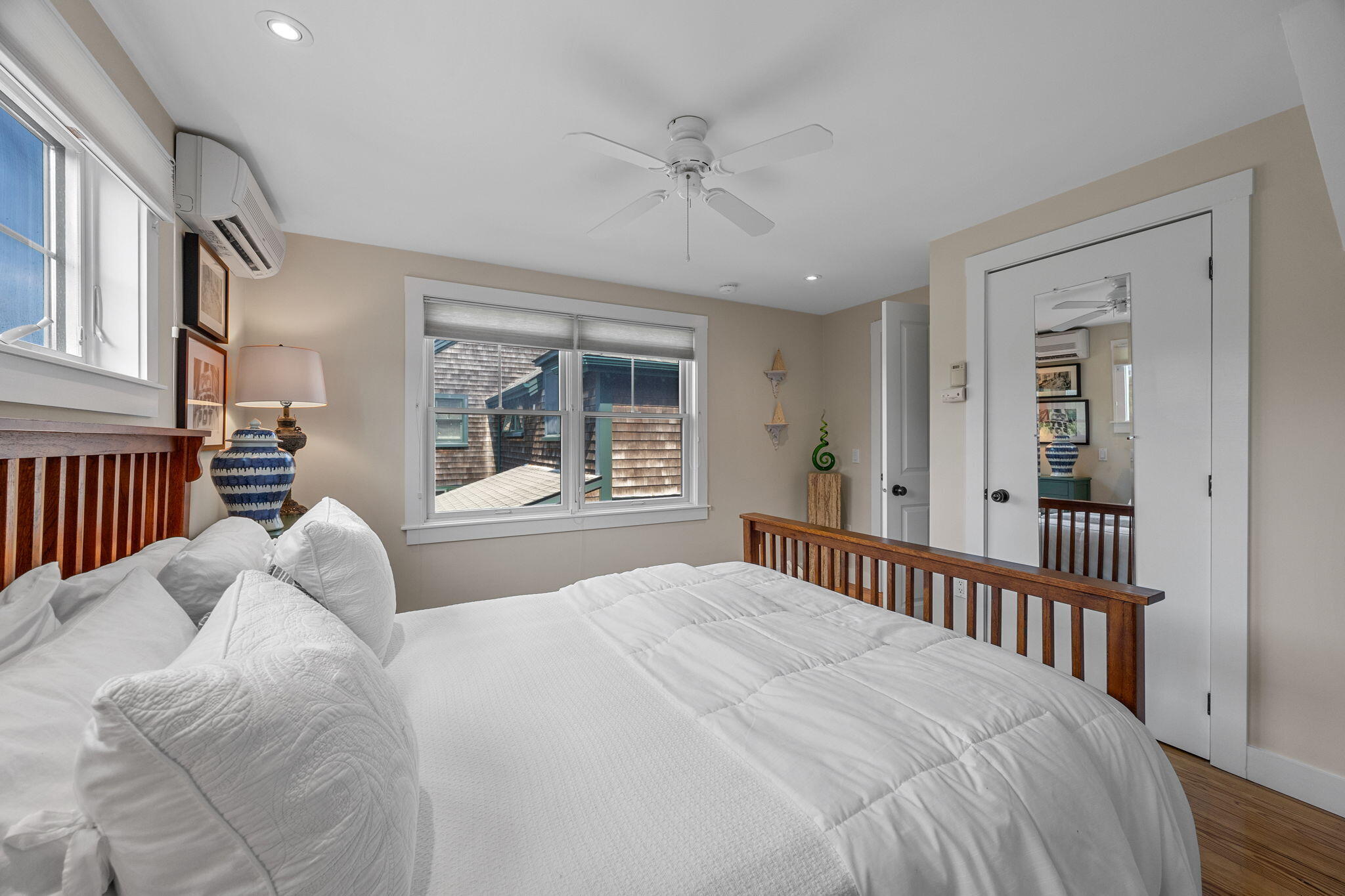 3 Meadow Road, Unit 2 Provincetown, MA 02657 - Photo 14 of 26 a bedroom with a large bed and a chandelier