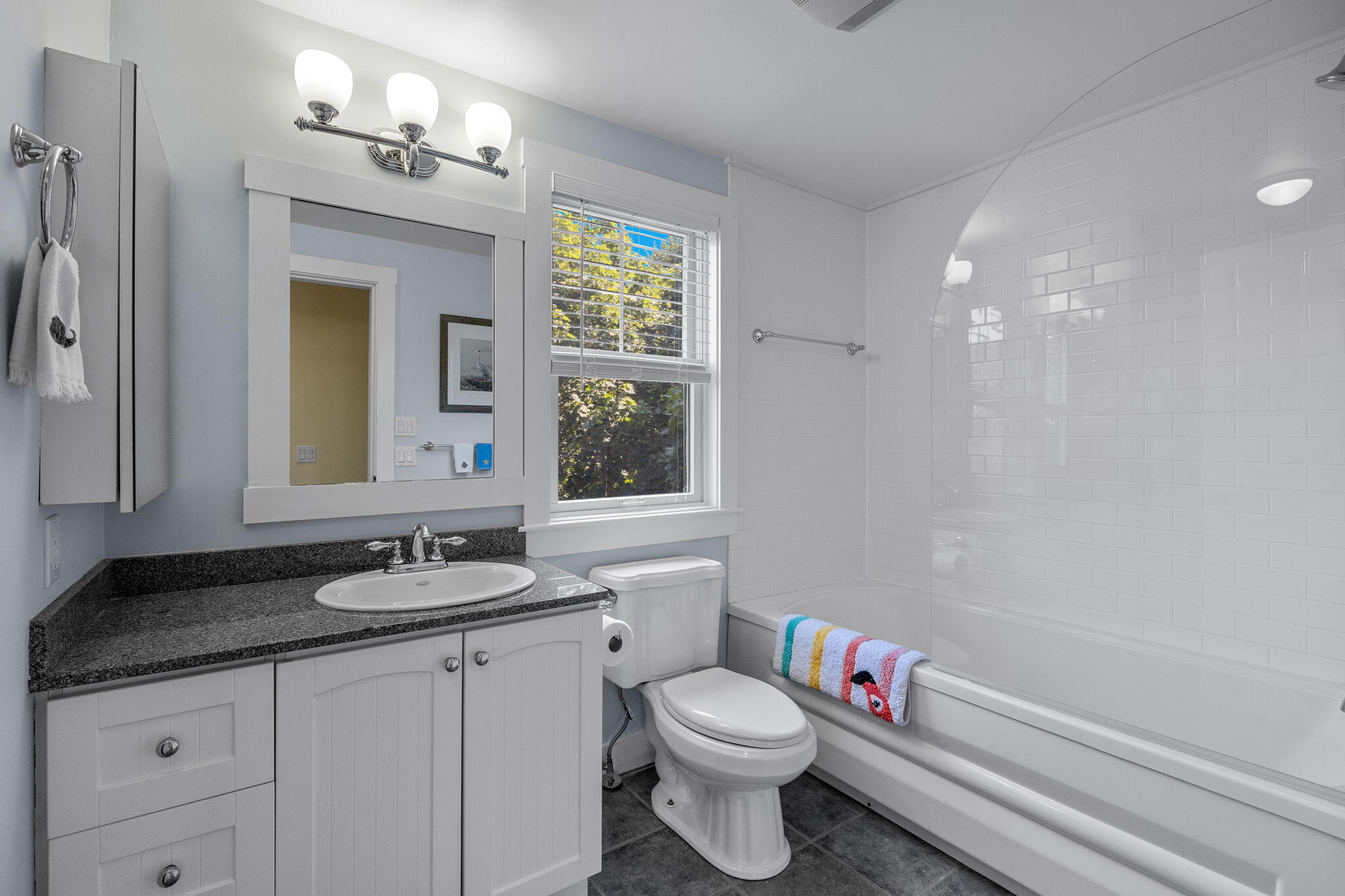 3 Meadow Road, Unit 2 Provincetown, MA 02657 - Photo 15 of 26 a bathroom with a granite countertop sink a toilet a mirror and shower