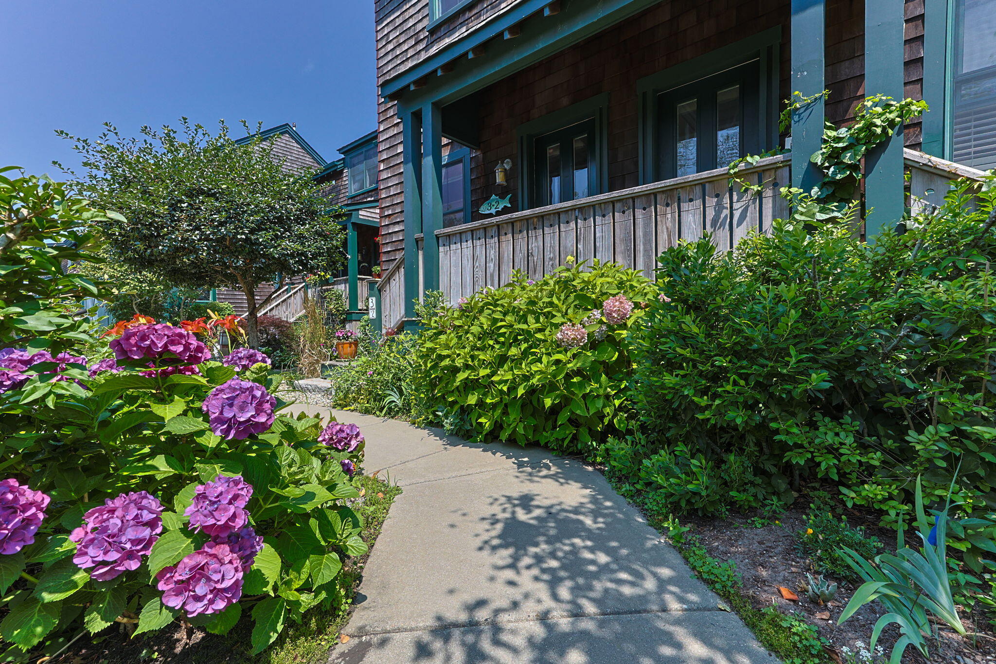 3 Meadow Road, Unit 2 Provincetown, MA 02657 - Photo 2 of 26 a view of flower garden with wooden fence