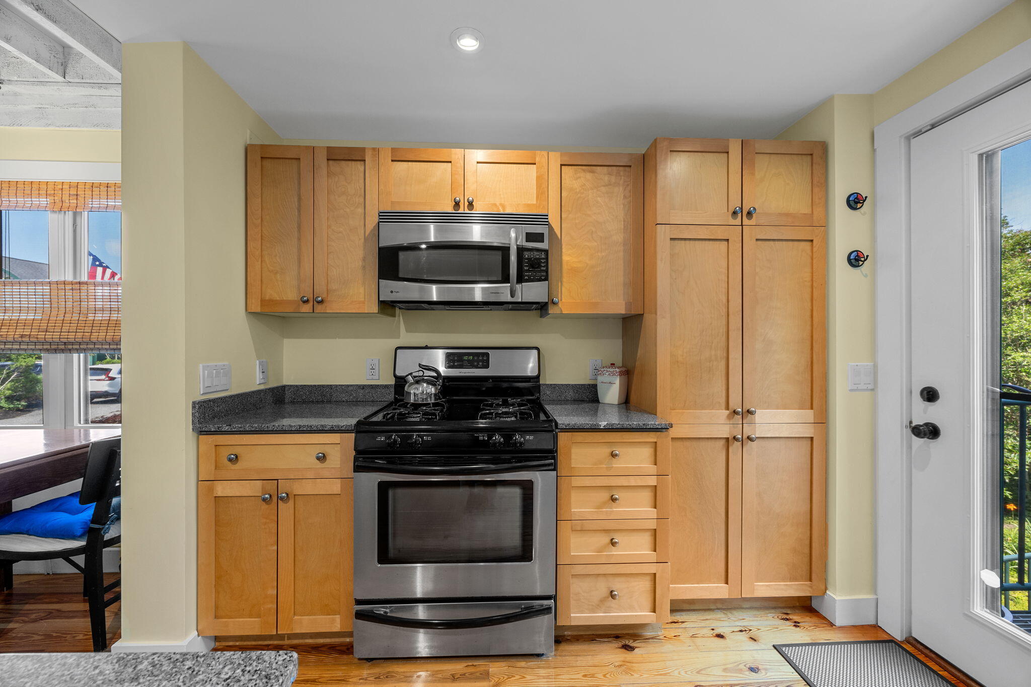 3 Meadow Road, Unit 2 Provincetown, MA 02657 - Photo 9 of 26 a kitchen with stainless steel appliances granite countertop a stove a microwave and a refrigerator