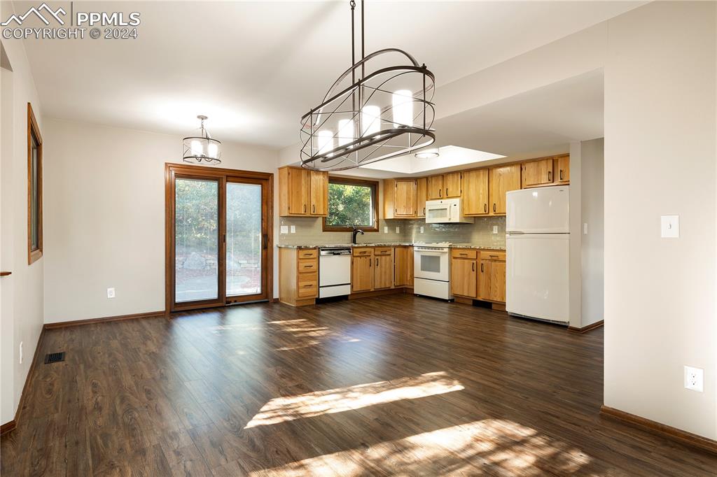 1125 Garlock Lane Colorado Springs, CO 80918 - Photo 12 of 49 a kitchen with stainless steel appliances granite countertop a stove and a wooden floors