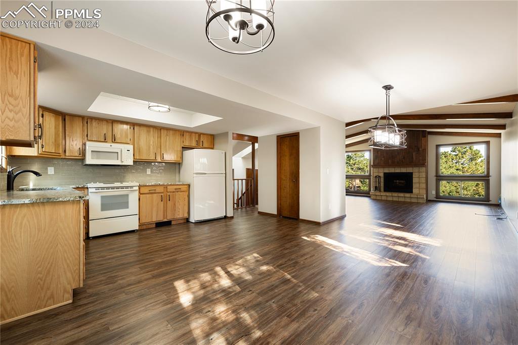 1125 Garlock Lane Colorado Springs, CO 80918 - Photo 13 of 49 a view of a kitchen with a sink a refrigerator and a stove top oven