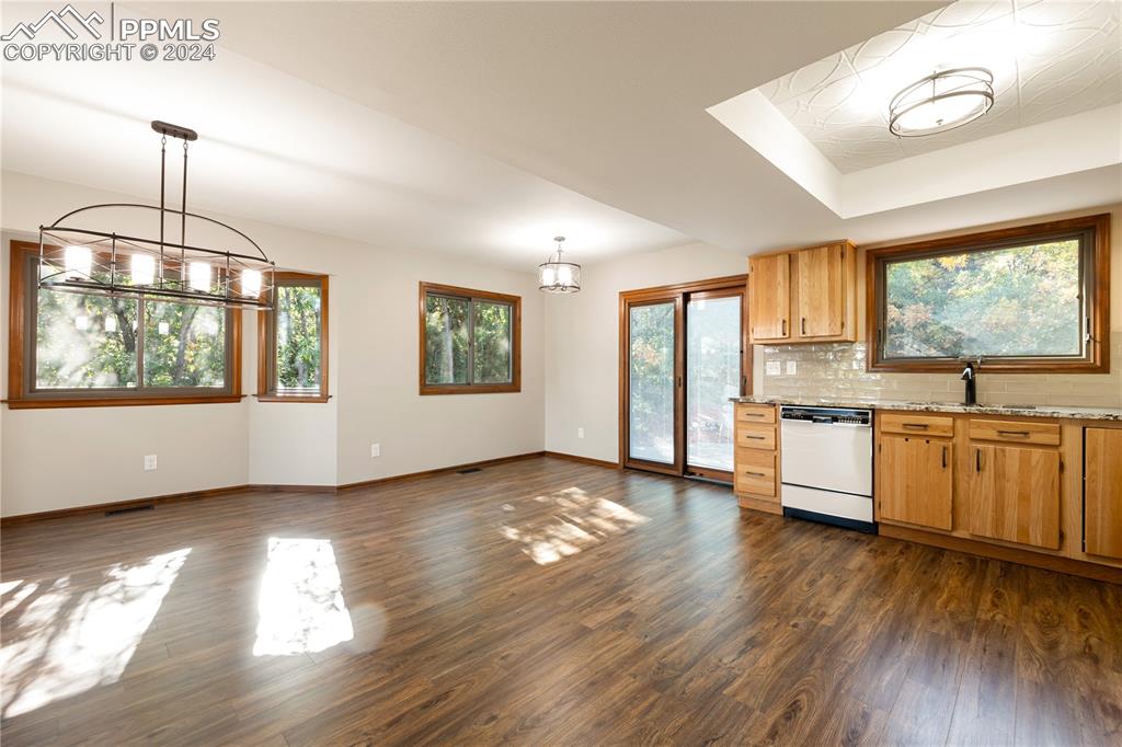 1125 Garlock Lane Colorado Springs, CO 80918 - Photo 16 of 49 a kitchen with stainless steel appliances granite countertop a stove a sink and a large window