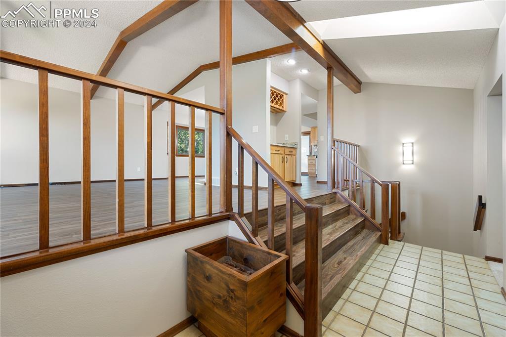 1125 Garlock Lane Colorado Springs, CO 80918 - Photo 20 of 49 a view of staircase with lots of frames on wall and a window