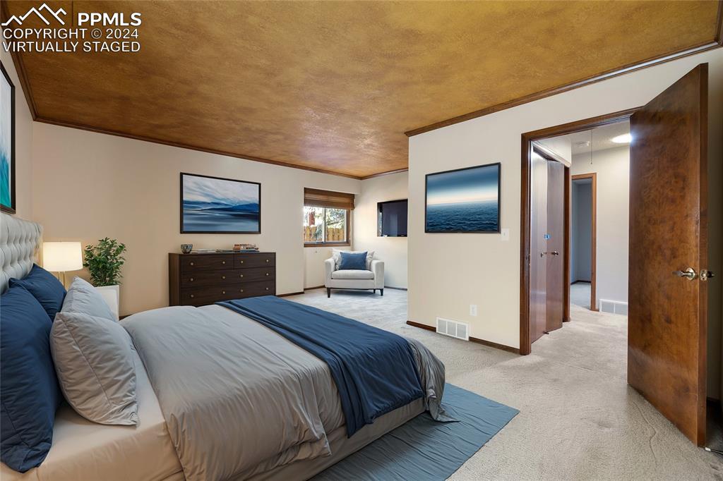 1125 Garlock Lane Colorado Springs, CO 80918 - Photo 24 of 49 a bedroom with a large bed and a chandelier