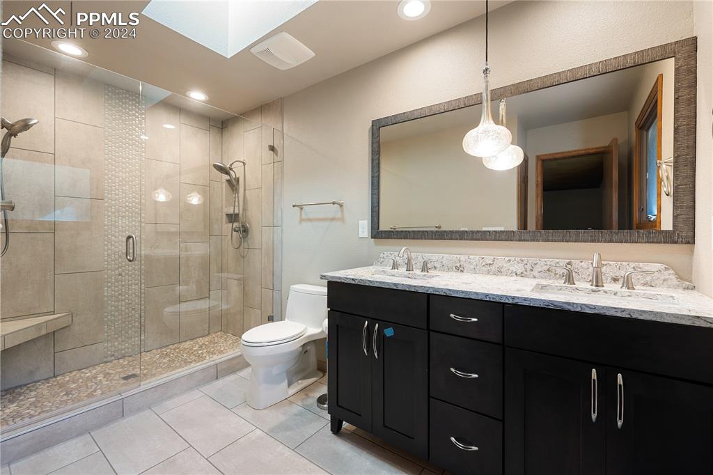 1125 Garlock Lane Colorado Springs, CO 80918 - Photo 28 of 49 a bathroom with a double vanity sink mirror and toilet