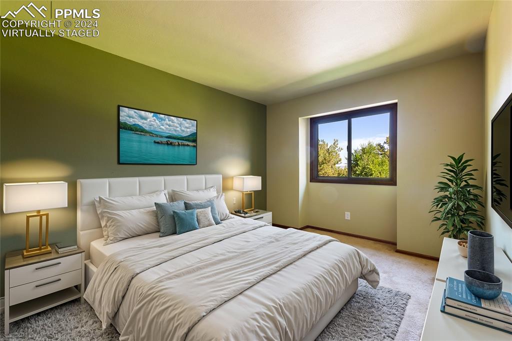 1125 Garlock Lane Colorado Springs, CO 80918 - Photo 31 of 49 a bedroom with bed painting on the wall and a potted plant