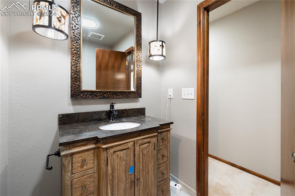 1125 Garlock Lane Colorado Springs, CO 80918 - Photo 34 of 49 a bathroom with a sink and a mirror
