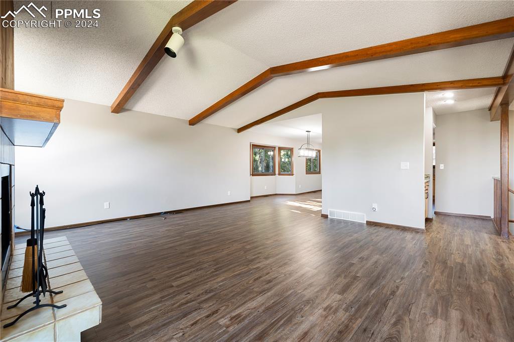 1125 Garlock Lane Colorado Springs, CO 80918 - Photo 9 of 49 a view of an empty room with wooden floor and a window