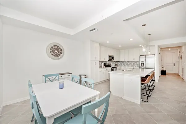 a living room with furniture a flat screen tv and a large window