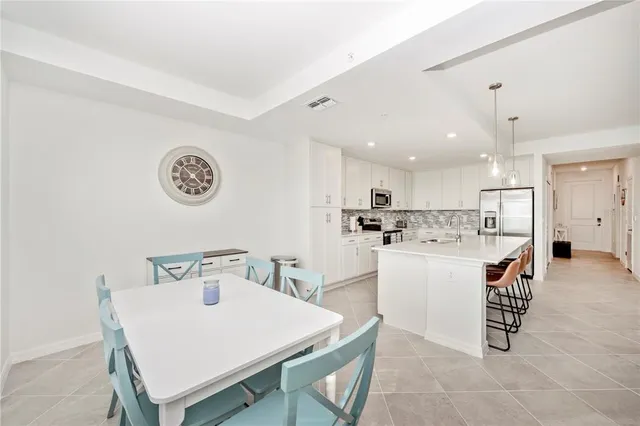 a living room with furniture a flat screen tv and a large window