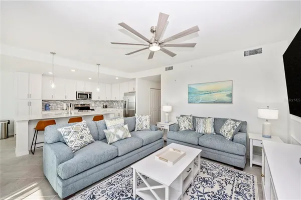 a living room with furniture and a floor to ceiling window