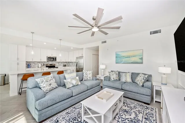 a living room with furniture and a floor to ceiling window