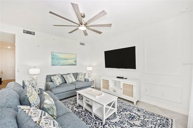 a bedroom with a bed tv on table and a flat screen tv
