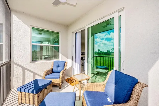 a bedroom with a large bed and a ceiling fan