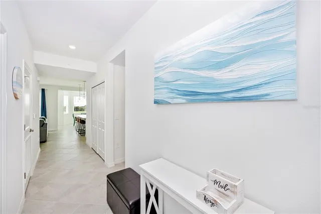 a kitchen with a dining table chairs refrigerator and cabinets