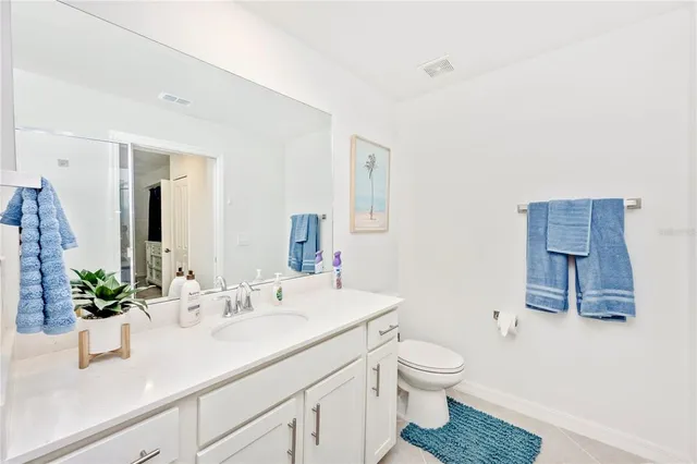 a swimming pool view with a seating space and a garden view