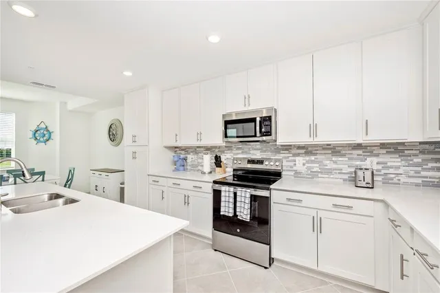 a kitchen with a sink cabinets and refrigerator