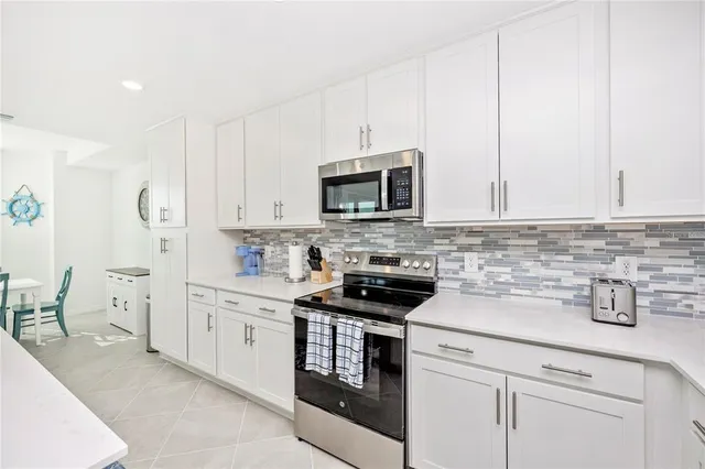 a large white room with a large window and furniture
