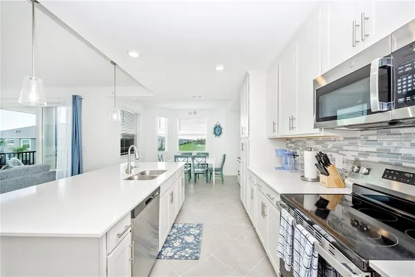 a kitchen with stainless steel appliances a sink and a refrigerator