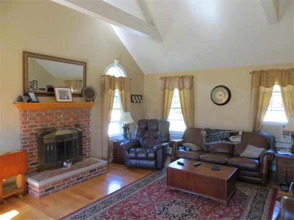 16 Winifreds Way Rutland, MA 01543 - Photo 8 of 22 a living room with furniture a fireplace and a large window