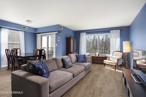 a living room with furniture and large windows