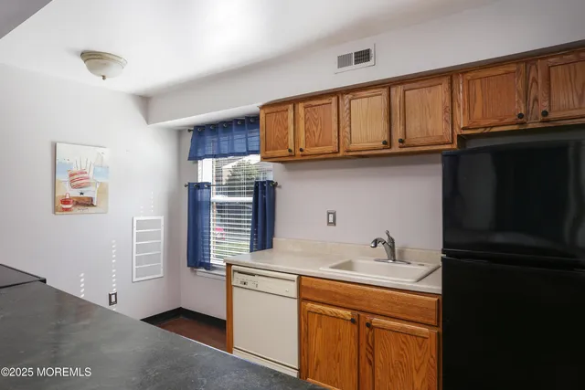 a kitchen with stainless steel appliances granite countertop a refrigerator stove and sink