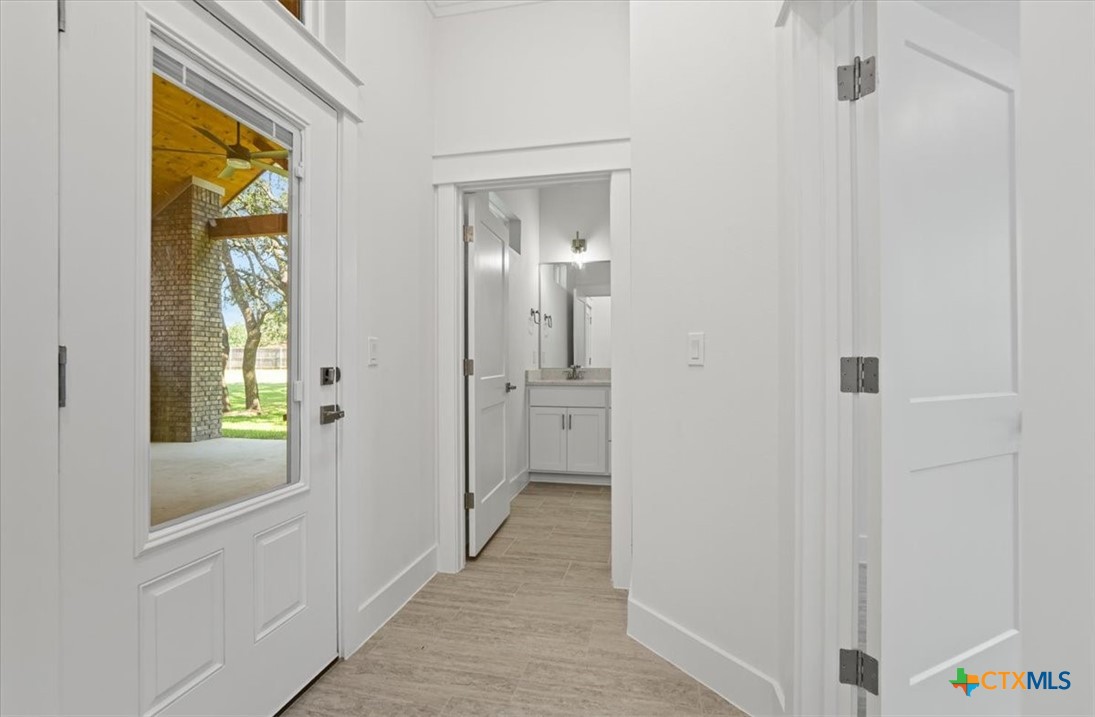 8439 Spring Creek Loop Salado, TX 76571 - Photo 33 of 40 Bathroom 3 with access to hallway - exterior patio door.