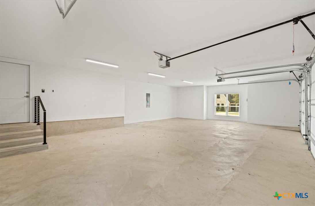 8439 Spring Creek Loop Salado, TX 76571 - Photo 35 of 40 Extra large 3 car garage - Access to attic by stairwell.