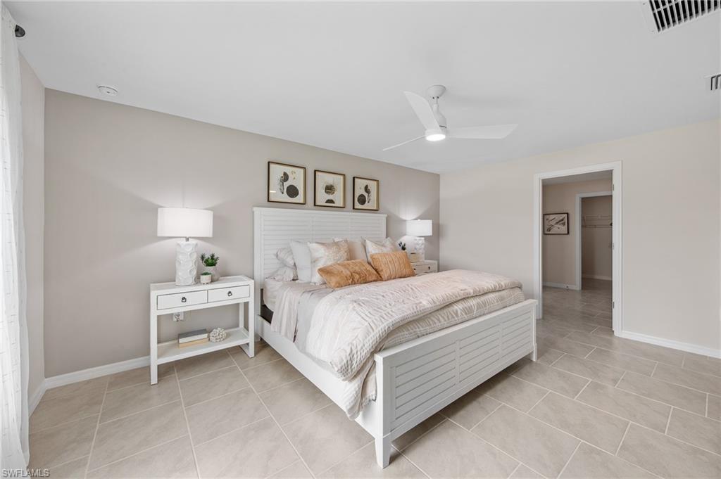 12265 Savanna Lakes Boulevard Lehigh Acres, FL 33936 - Photo 14 of 31 Bedroom featuring light tile patterned flooring and a ceiling fan