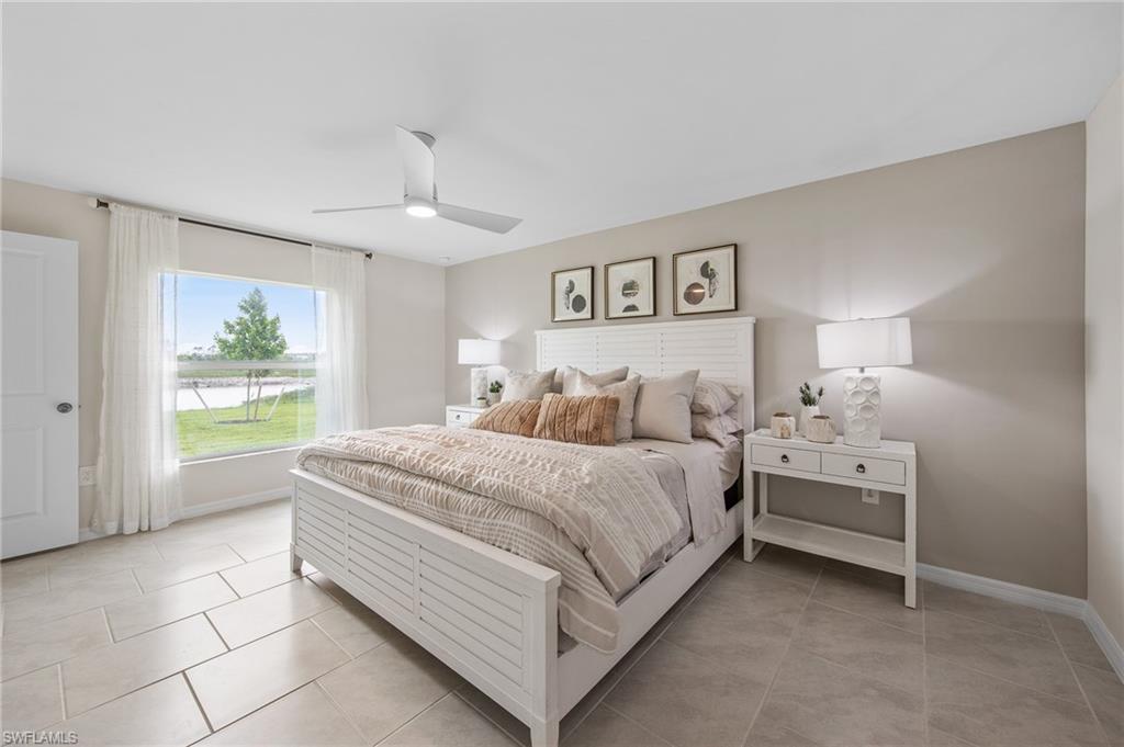 12265 Savanna Lakes Boulevard Lehigh Acres, FL 33936 - Photo 15 of 31 Bedroom featuring light tile patterned flooring and a ceiling fan