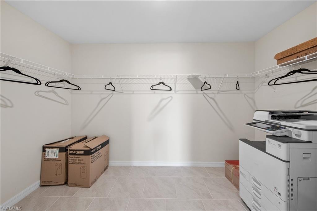 12265 Savanna Lakes Boulevard Lehigh Acres, FL 33936 - Photo 17 of 31 Walk in closet featuring light tile patterned floors