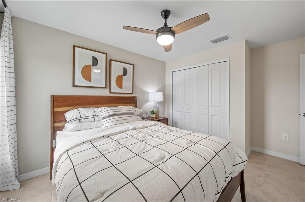 12265 Savanna Lakes Boulevard Lehigh Acres, FL 33936 - Photo 18 of 31 Bedroom with a closet, light tile patterned floors, and ceiling fan