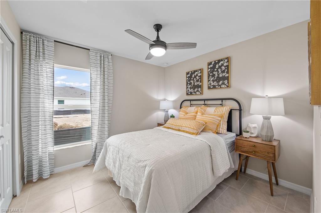 12265 Savanna Lakes Boulevard Lehigh Acres, FL 33936 - Photo 20 of 31 Bedroom featuring light tile patterned floors and ceiling fan