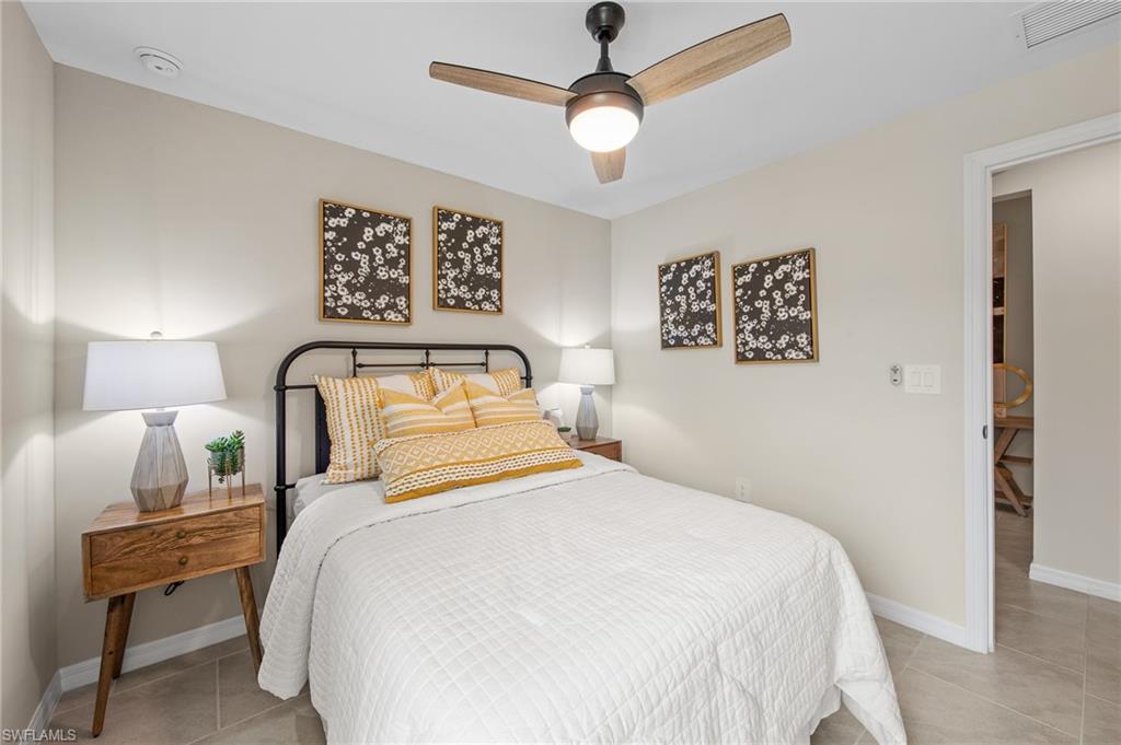 12265 Savanna Lakes Boulevard Lehigh Acres, FL 33936 - Photo 21 of 31 Bedroom with light tile patterned flooring and a ceiling fan